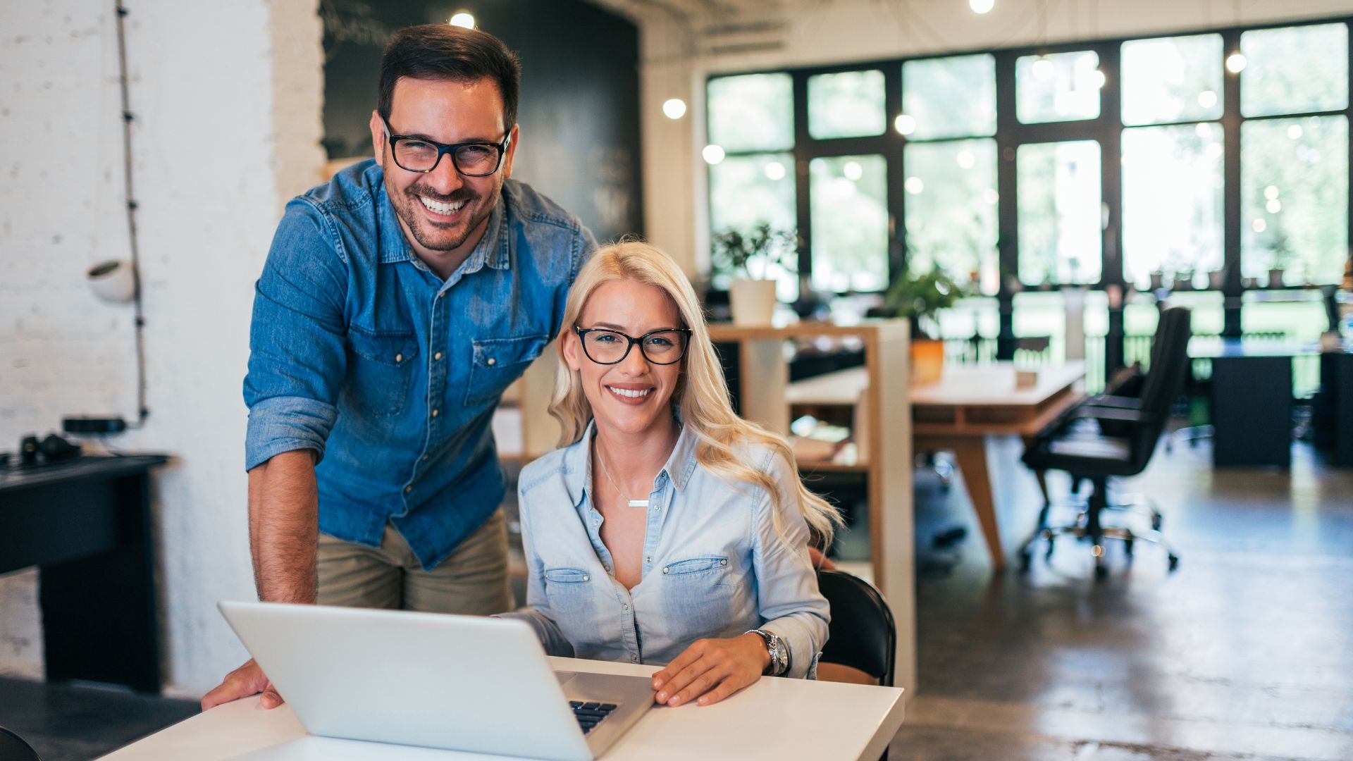 two business owners smiling at camera